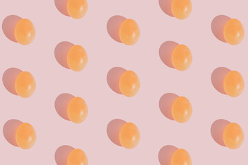 Glossy egg pattern on gentle pink background. Minimal Easter concept. Flat lay aesthetic.