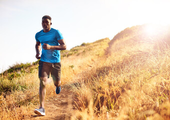 Make fitness your focus. Shot of a sporty young man out for a run.