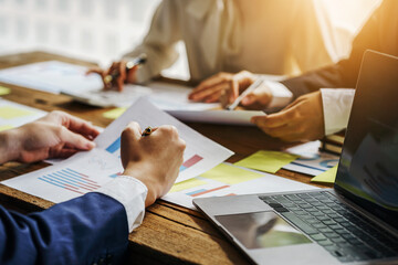 Three of business people working together in the meeting room office with paper charts, discussing and planning concept.