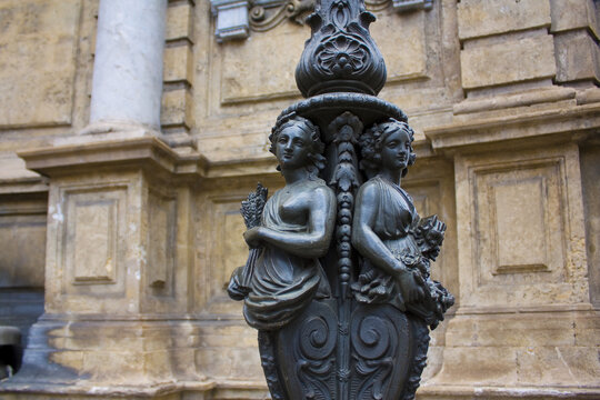 Fragment of a street lamp with female figures in Palermo, Sicily, Italy