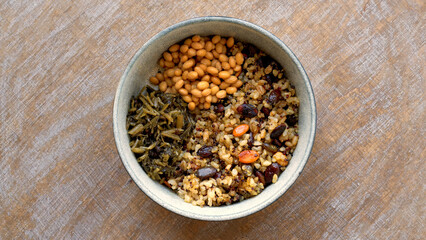 Natto soybeans with rice with quinoa and pumpkin seeds and pickled leaves vegetables meal top view.