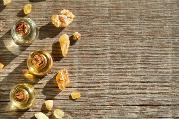 Bottles of aromatherapy essential oil with frankincense resin, with empty space