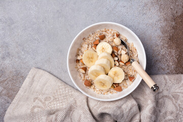 Healthy breakfast with oatmeal, nuts and banana
