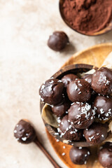 Vegan chickpea and peanut butter candies in chocolate glaze sprinkled with coconut chips. Energy balls. Healthy raw dessert without sugar.