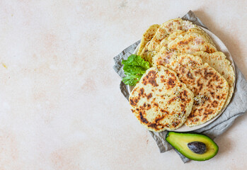 Fresh naan bread with avocado and sprouts, concrete background. Traditional homemade wheat flour...