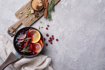 Mulled wine with slices of citrus fruits, berries and aromatic spices
