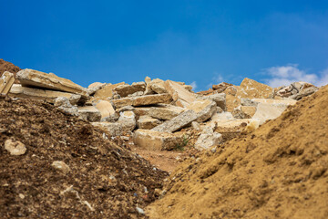 Fototapeta na wymiar A view of the rubble pile of concrete blocks obtained from the demolition of an old road.