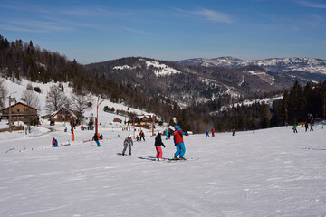 Skiers on slope in european Bialy Krzyz in Poland