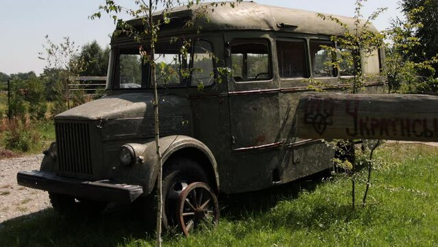 Vintage van on a rural road. Old vintage bus retro style. Ruined school bus. Old retro dirty van with. Vintage antique soviet russian car bus. Side view.