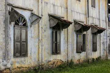 Vintage wooden windows with awnings of a heritage house in the old town of Papan in Ipoh, Malaysia.