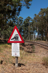 , train warning sign alongside track.
