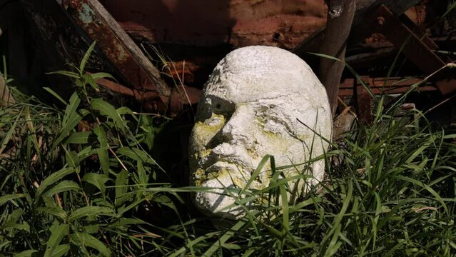 Lenin monument. Lenin's head. Summer. Sculpture of vladimir monument to lying on the grass. Vladimir ilyich marble sculpture bust, Russian revolutionary
