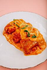 meatballs on a white plate on a black background