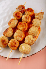 meatballs on a white plate on a pink background