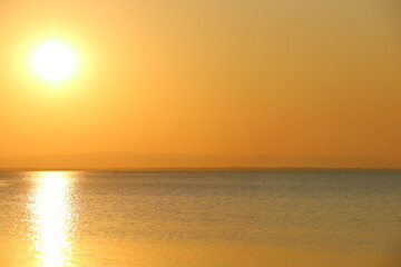 Sunset or sunrise over dam.