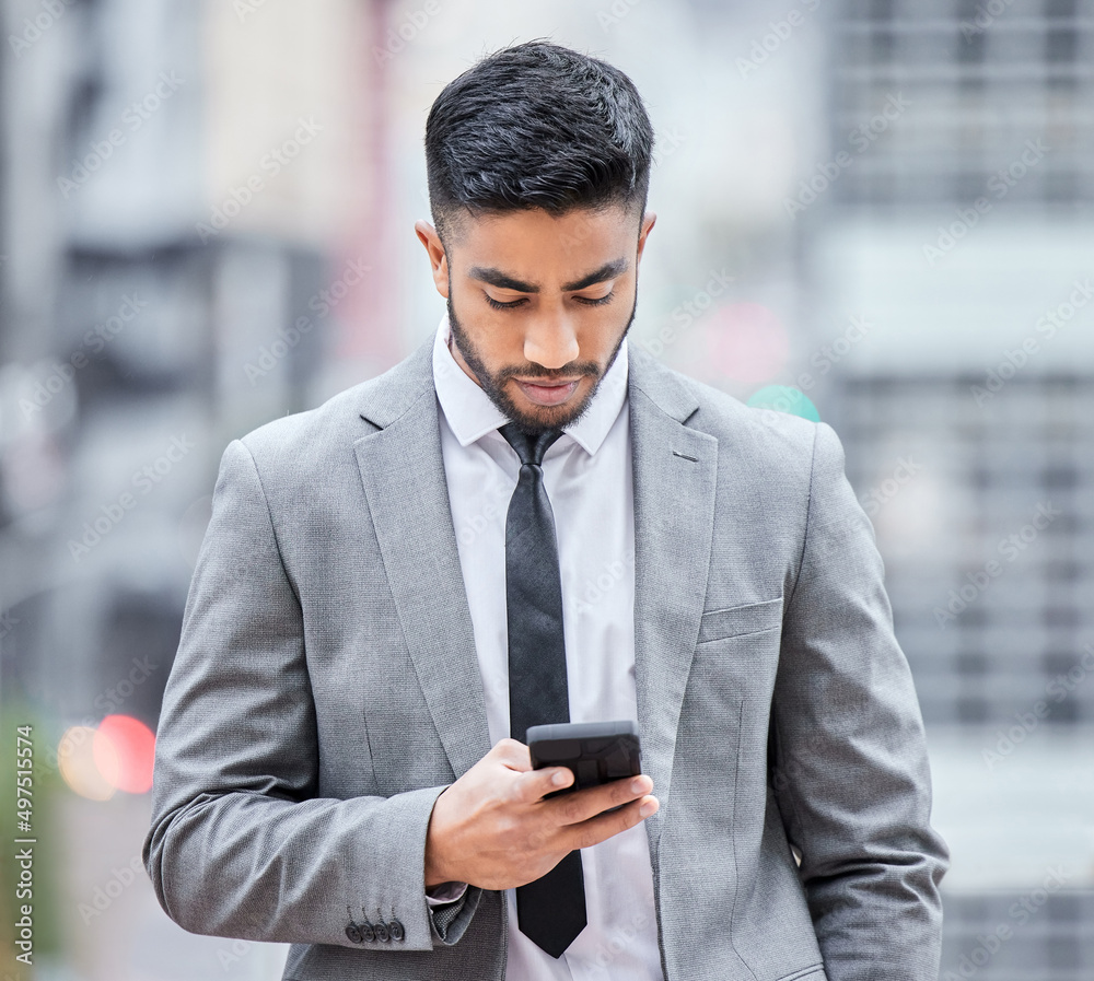 Poster you have until the end of the business day. shot of a young businessman using his smartphone while w