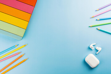 Back to school. School supplies on a blue background. Children's multi-colored accessories like...