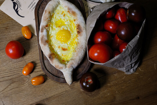 ajara Khachapuri with cheese and egg georgian kitchen on old wooden table close up