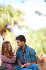 Fototapeta premium What we found in each other is precious and priceless. Shot of a smiling young couple enjoying the day together at the park.