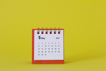 Desktop calendar for May 2022 for planning.Spring is in the yard.