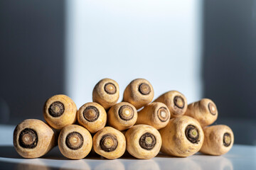 A brightly lit pile of raw parsnip roots. Selective focus.