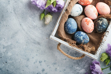Easter eggs. Dyed Easter eggs with marble stone effect ref and blue color in rustic style on light...