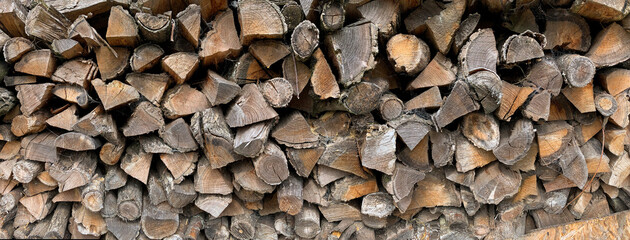 Stacks of Firewood. Preparation for the winter. Wood for the fireplace. Natural background.