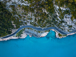 Aerial view of Aurelia street in Noli, Capo Noli and Varigotti, province of Savona. Drone photography from above of snake street snake in Liguria, north Italy, near Bergeggi and Spotorno.