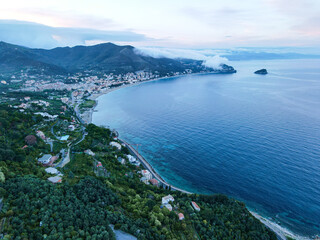 Obraz premium Aerial view of Monte Ursino castle, ancient tower in the old village of Noli on the Ligurian Riviera in north Italy. Drone photography in Liguria, near Noli, Spotorno and Bergeggi.