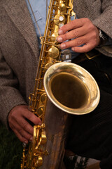Close-up of a saxophone. Hands playing a saxophone. Musical instruments