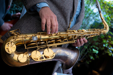 Close-up of a saxophone. Hands playing a saxophone. Musical instruments