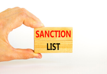Sanction list symbol. Wooden blocks with concept words Sanction list on beautiful white background. Businessman hand. Business political sanction list concept. Copy space.