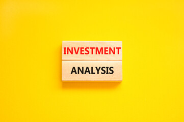 Investment analysis symbol. Wooden blocks with concept words Investment analysis on beautiful yellow background. Business investment analysis concept. Copy space.
