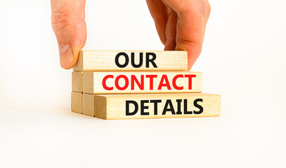 Our contact details symbol. Concept words Our contact details on wooden blocks. Businessman hand. Beautiful white table white background. Business our contact details concept. Copy space.