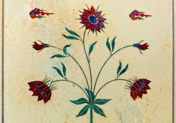 Beautiful inlaid decorative flower created with semi precious stones on white marble panel on...