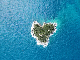 Aerial view of Bergeggi island, heart island from above, in Liguria, north Italy. Drone photography of the Ligurian coast, province of Savona with Spotorno and the island of Bergeggi.