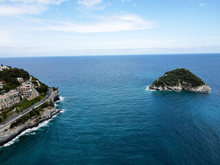 Obraz premium Aerial view of Bergeggi island, heart island from above, in Liguria, north Italy. Drone photography of the Ligurian coast, province of Savona with Spotorno and the island of Bergeggi.