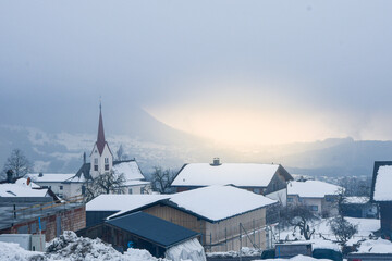 Fototapeta premium Photo of a town during cloudy weather and sunset