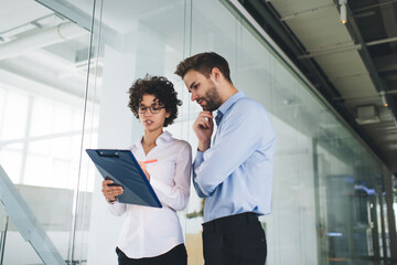 Millenial business man and woman working in office