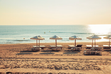 beach umbrellas and sun loungers on the beach early in the morning