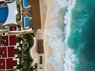 Aerial top down view of a rooftop pool and hotel in Cancun, Mexico. Amazing ocean beach from above