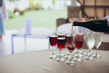 catering, the waiter pours alcohol into glasses