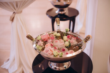 bottles of champagne and beer in a basket with ice