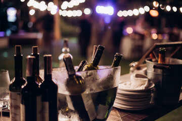 bottles of champagne and beer in a basket with ice