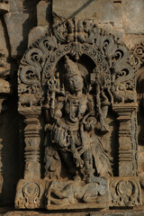 Stone Sculpture of Beautiful with selective focus, 12th century Hindu temple, Ancient stone art and sculptures in each pillars, Chennakeshava Temple, Belur, Karnataka, India.
