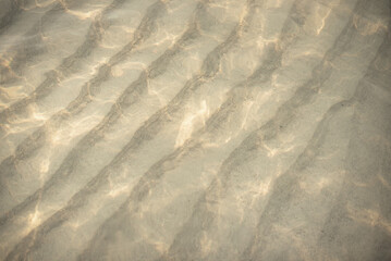 Reflection​ on​ surface​ clean water​ in​ the​ sea. Abstract​ of​ surface​ orange​ water​ for​ background. Closeup​ abstract​ of​ surface​ water. beach scene vacation and summer holiday concept.