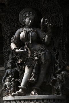 Stone Sculpture of Beautiful Female (Madanikas) with selective focus, 12th century Hindu temple, Ancient stone art and sculptures in each pillars, Chennakeshava Temple, Belur, Karnataka, India.