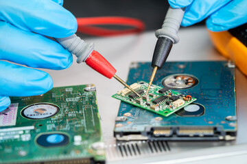 Obraz premium Technician repairing inside of mobile phone by soldering iron. Integrated Circuit. the concept of data, hardware, technology.