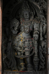 Fototapeta premium Stone Sculpture of Hindu Gods with selective focus, 12th century Hindu temple, Ancient stone art and sculptures in each pillars, Chennakeshava Temple, Belur, Karnataka, India.