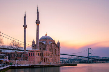 Ortakoy Mosque and Bosphorus Bridge at sunrise in winter